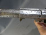 a hand that is holding a metal pipe that is leaking