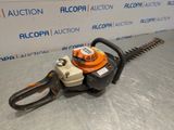 a chainsaw is sitting on a table in front of a sign