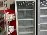 two refrigerators that are in the middle of a store