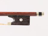 a close up of a violin bow with a piece of wood sticking out of it