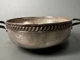 a silver bowl that is sitting on a table