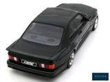 a black toy car that is sitting on a white surface