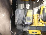 yellow and black tools sitting on top of a car seat in the back of a vehicle