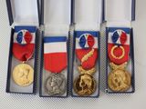 four medals are in a blue box on a white surface