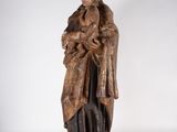 a wooden statue of a man with a crown on his head