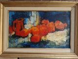 a painting of oranges in a gold frame on the wall