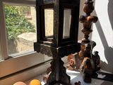 a table with a lamp and some oranges on it