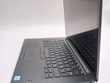a laptop that is open on a white surface