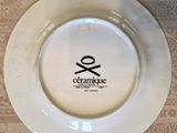 a white plate with a black and white logo on it