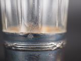 a close up of a glass with a liquid inside of it
