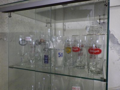 a glass display case with a lot of bottles on it