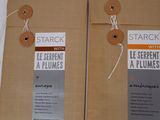 two brown bags with tags attached to them on a table