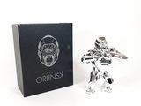 the silver figurine is next to a black box with a logo on it