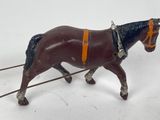 a toy horse pulling a sleigh on a white surface