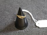 a black cone with a gold ring on top of it