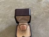 an image of a ring in a box on the floor