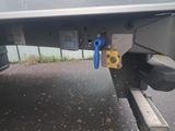 a close up of a car ' s rear end with a blue handle