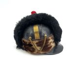 a black hat with fur and a gold chain around it