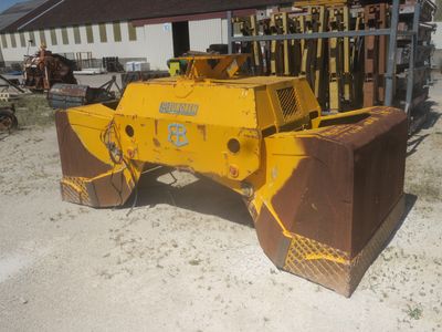 a yellow bulldozer parked in front of a building