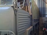 a military truck that is parked in a garage