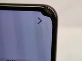 a close up of a cell phone with a broken screen