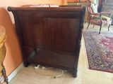 a bed with a wooden headboard and foot board in a room