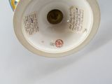 a white vase with a blue and yellow design on it