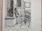 an open book with a drawing of a kitchen and a clock