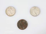 three different types of coins are shown on a white surface