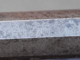 a close up of a bench with a sign on it