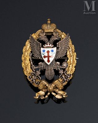 an image of a gold and silver broochle with a cross and two headed eagle