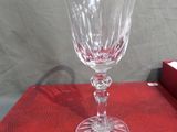 a wine glass sitting on a table with a red cloth