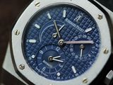 a close up of a watch with a blue dial