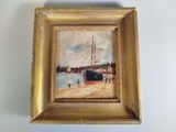 an oil painting of a ship in a gold frame on a white wall