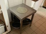 une petite table sur laquelle se trouve un saladier, dans une cuisine