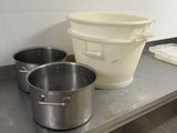stainless steel counter top with pots and pans on it in a kitchen