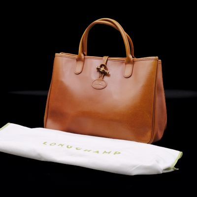 a brown bag and a white towel on a black background