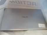 a laptop computer sitting on a bed with a box on it