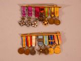 two medals hanging on the wall next to each other
