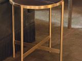 a black and gold side table with books on top of it