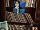 a book shelf with a lot of records on it