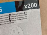 someone is holding a box with a pair of face masks on it