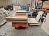 many pieces of wood on the floor in the warehouse