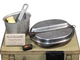 an old suitcase with a pot and pan on top of it