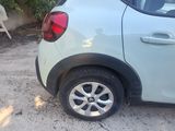 a small car that is parked on the side of the road