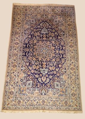 a blue and beige rug with a medallion design on it