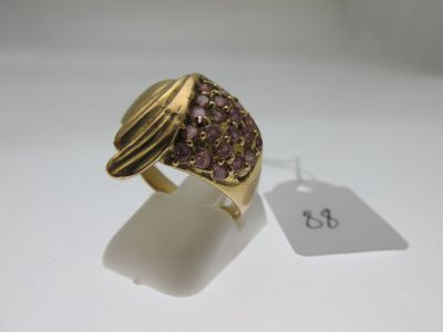 a close up of a gold ring with purple stones on it