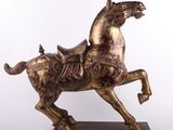 bronze statue of a horse with a rider on it ' s back