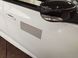 a close up of a white car with a black door handle
