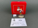 the figurine is in a red box on the table